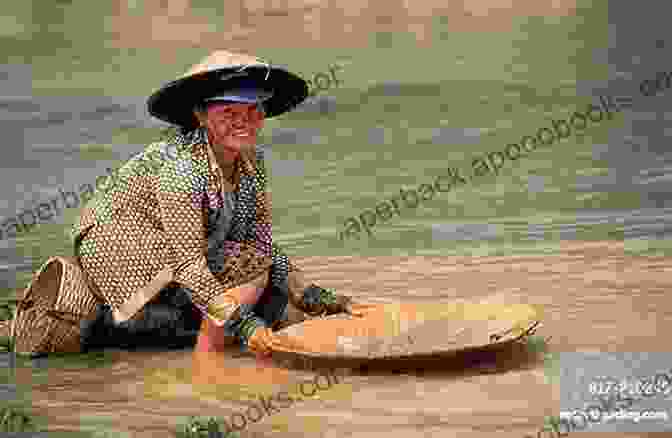 A Woman Panning For Gold In A River The Gold In These Hills